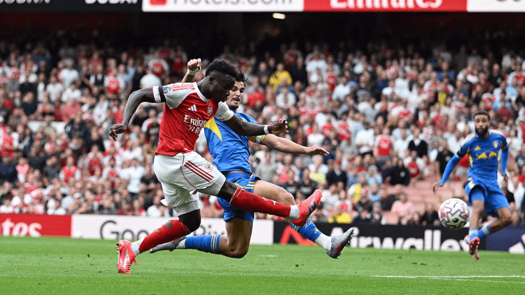 Saka against a Leeds player during Arsenal 5-0 victory over Leeds in August. (Credit: Arsenal media)