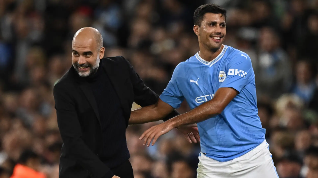 Manchester City coach Pep Guardiola and player Rodri (Photo Credit: Manchester City facebook page)
