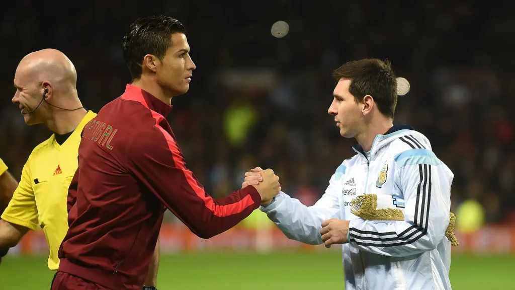 Cristiano Ronaldo and Lionel Messi shaking hands - Photo Credit : Softfootball Media