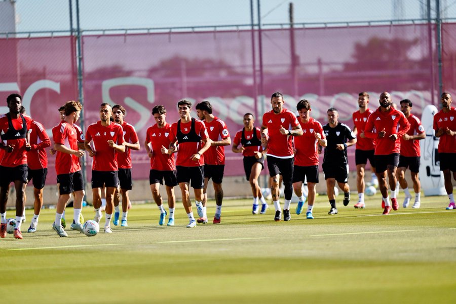 Sevilla squad warming up on the training pitch- Photo credit: Sevilla media


