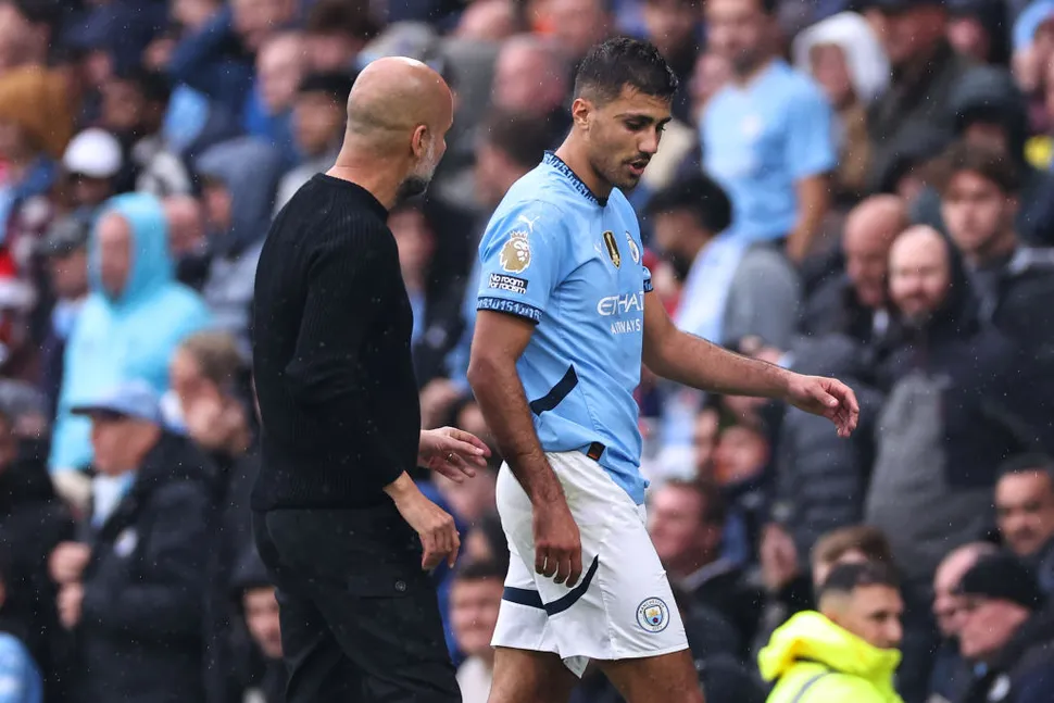 Manchester City coach Pep Guardiola and player Rodri (Photo Credit: Manchester City website)