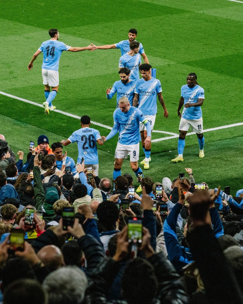 Manchester City players celebrate in front of fans after scoring against Dortmund in the UCL (Photo Credit: Manchester City X handle)