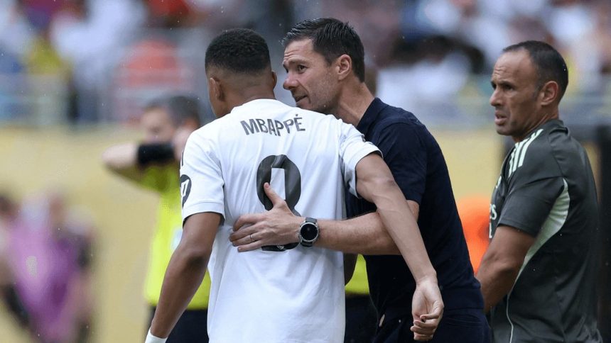 Kylian Mbappe hugs Xabi Alonso. (Photo credit: Real Madrid Media).