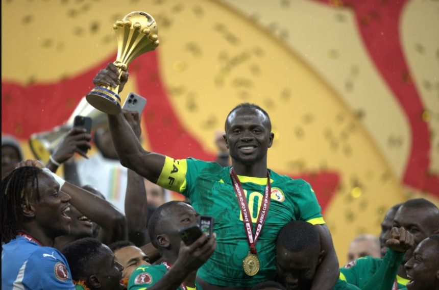 Saido Mane lifting the AFCON title. (Photo Credit: CAF Media).